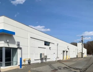 Commercial building with white EIFS exterior walls and blue accent trim in East Brunswick, NJ by CMB Stucco