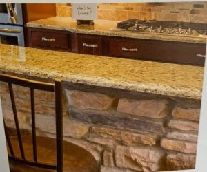 Kitchen island with cultured stone veneer base and granite countertop in East Brunswick, NJ by CMB Stucco